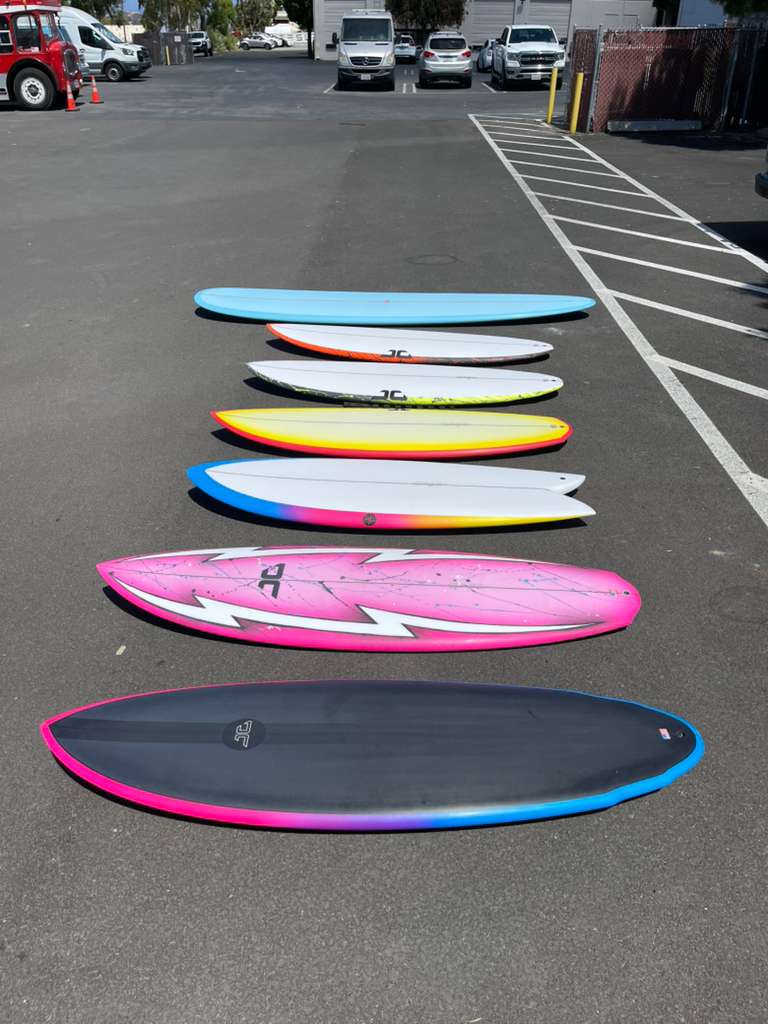 Colorful lineup of Jonathan Grandini surfboards